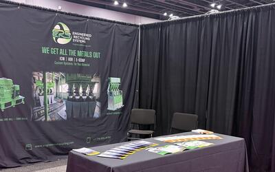 The ERS booth at CEBNA 2026 in Atlanta, with the backdrop banner showing the Turbo 900/5 mill, a wire processing line and an air density separation table.
