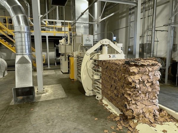 ERS vacuum transfer system moving trim and scrap into a baler at a corrugated facility.