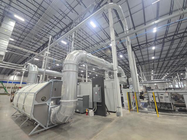 Engineered Recycling Systems CCM® OCT Filter installed in a corrugated manufacturing facility, showcasing 2025 model with modular segments, rotating anti-static suction nozzles, and positive-pressure airflow for high-efficiency dust filtration.