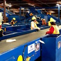 Slider bed conveyor systems utilized by Engineered Recycling Systems — flat-belt conveyors designed for efficient horizontal transport of scrap materials including metals, plastics, and cardboard, featuring smooth belt surface for consistent material flow