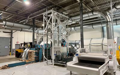 Engineered Recycling Systems LLC backend system for corrugated and cardboard trim and dust handling with CCM filtration, baler integration, dust briquetting, and front‑end shredding.