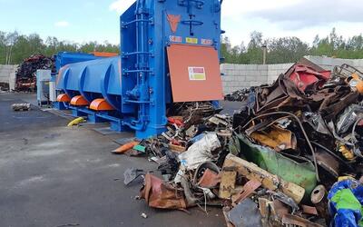 ERS HAKA entry-level shear baler processing mixed scrap metal at an outdoor recycling yard.