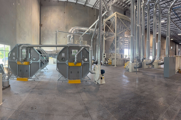 Two ERS CCM OCT Filter Systems installed for dust collection with an ERS Low Profile Separator in the background, showing integrated scrap and dust removal in a compact facility layout