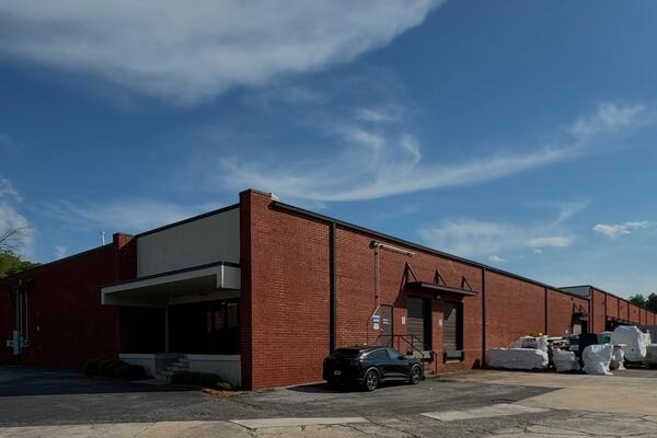 The Engineered Recycling Systems building in Atlanta, Georgia, with loading docks and equipment staged outside.