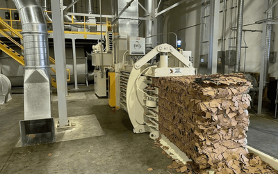 ERS vacuum transfer system moving trim and scrap into a baler at a corrugated facility.