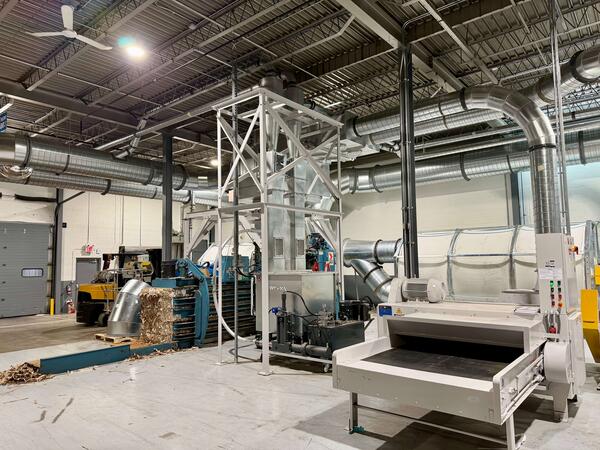 Engineered Recycling Systems LLC backend system for corrugated and cardboard trim and dust handling with CCM filtration, baler integration, dust briquetting, and front‑end shredding.