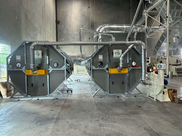 Two ERS CCM® Dust Collection Filters being installed at a corrugated manufacturing facility in 2025