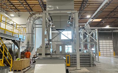 Engineered Recycling Systems — engineeredrecycling.com — news image representing trim and matrix removal efficiency for paper and corrugated converting lines, showing clean airflow and waste extraction concept for 2026 production trends