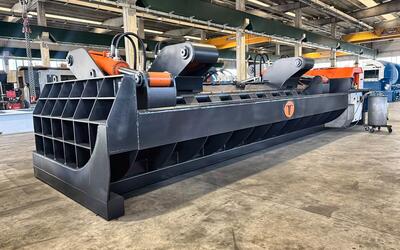 Steel transport rack recycling with the MIZAR baler supplied by ERS, showing the tank shaped compression chamber and twin swinging lids used to compact bulky end-of-life racks.