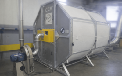 Photorealistic close-up of ERS CCM OCT filter module installed on a tissue dust collector in a converting line, showing source-capture hood and accessible filter cartridges.