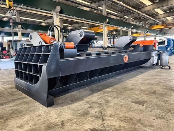 Steel transport rack recycling with the MIZAR baler supplied by ERS, showing the tank shaped compression chamber and twin swinging lids used to compact bulky end-of-life racks.