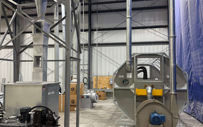 Engineered Recycling Systems CCM® OCT Filter installation in progress at a high-graphic printing and packaging facility, showing ductwork and mechanical components engineered for high-volume dust control and stable airflow.