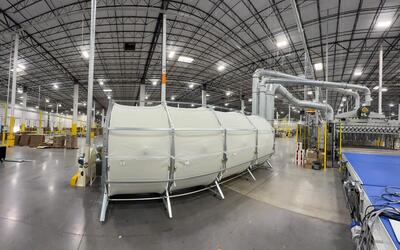 ERS integrated dust filter system operating alongside a corrugated production line—showcasing in-house scrap and dust recovery without external housings or rotary airlocks.