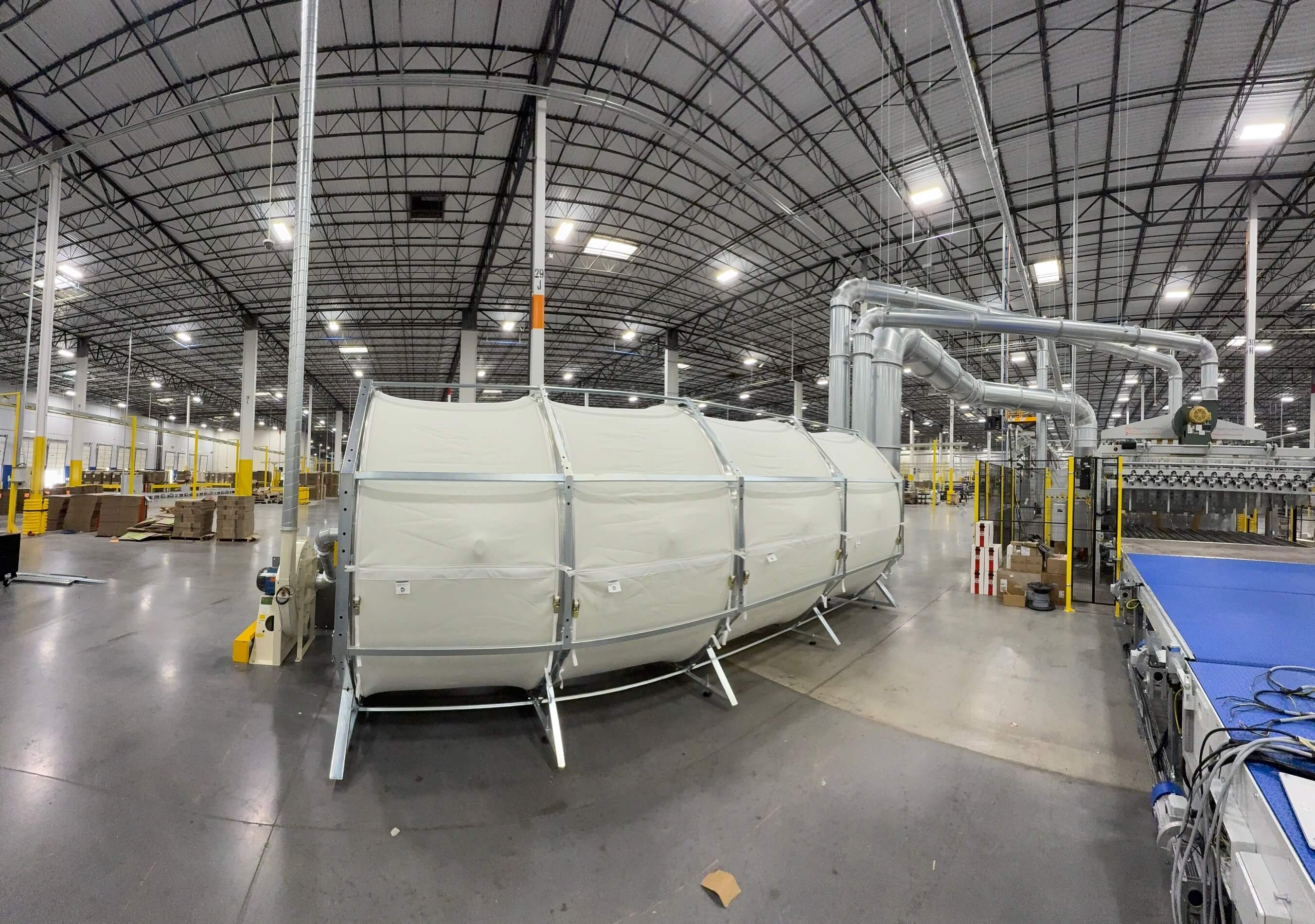 ERS integrated dust filter system operating alongside a corrugated production line—showcasing in-house scrap and dust recovery without external housings or rotary airlocks.